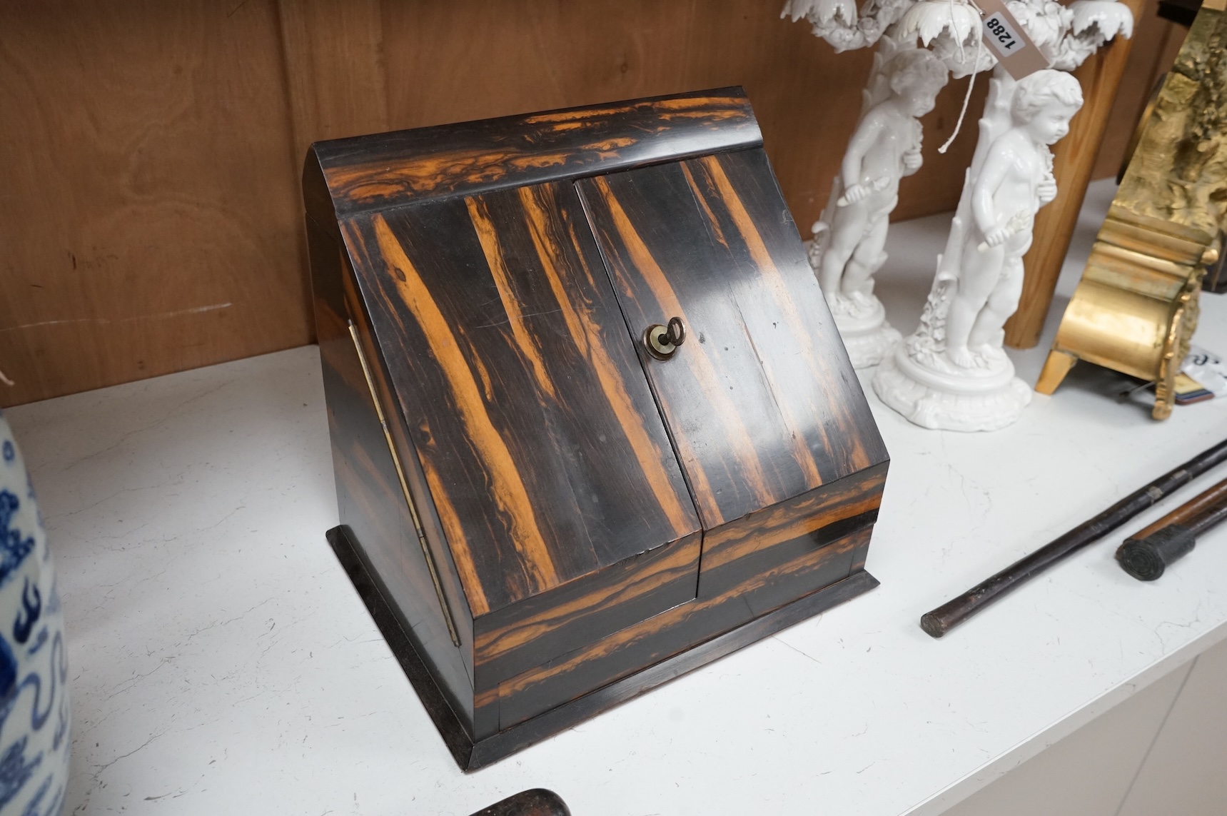 A coromandel desk top stationery box with letter rack and calendar, 29cm wide